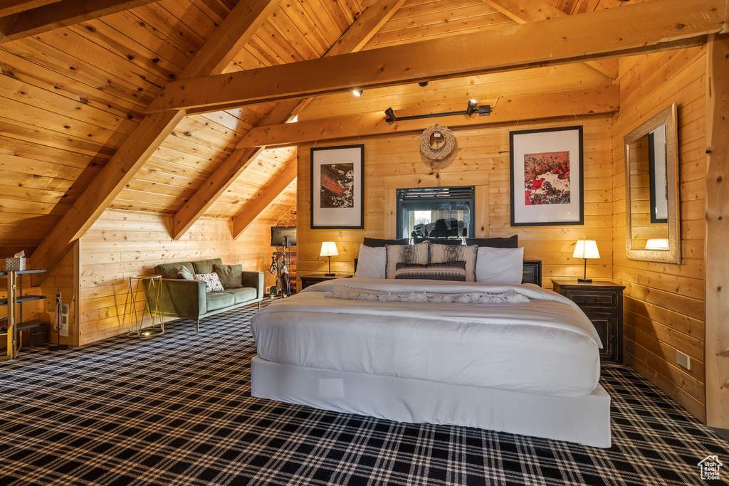 Bedroom featuring vaulted ceiling with beams, wood walls, and wood ceiling