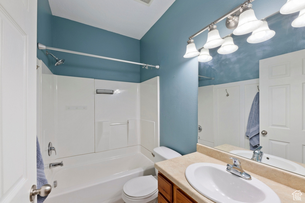 Full bathroom featuring vanity, toilet, and bathtub / shower combination