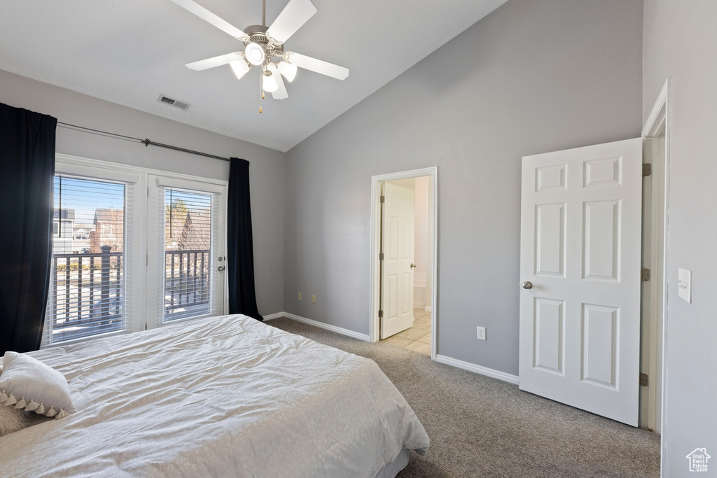 Bedroom featuring ensuite bathroom, access to outside, ceiling fan, high vaulted ceiling, and light carpet