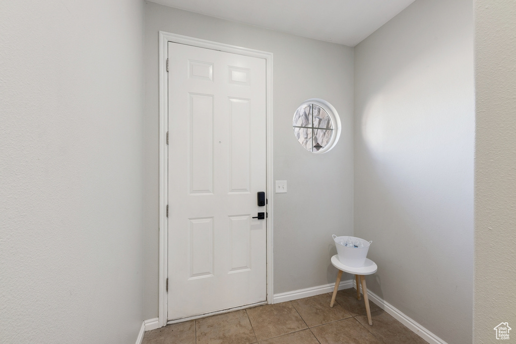 Doorway to outside featuring light tile floors