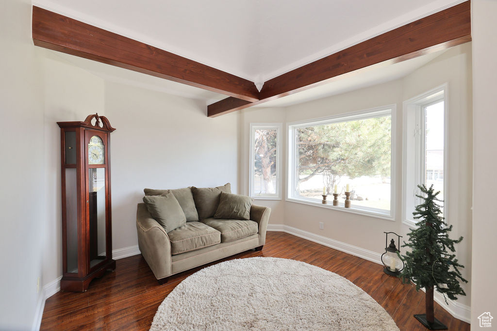 Living room with beam ceiling and dark hardwood / wood-style floors