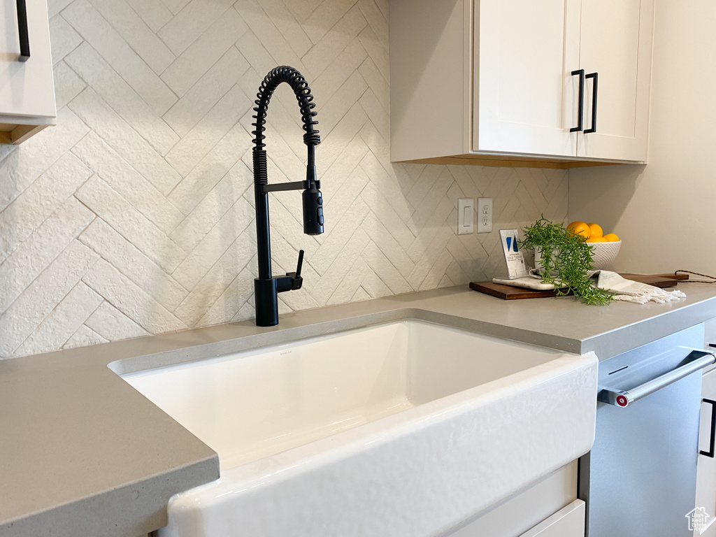 Interior space featuring white cabinetry and sink