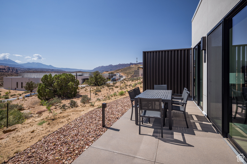 View of patio with a mountain view and outdoor dining space