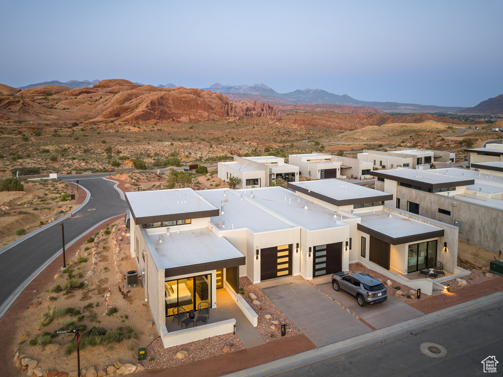 View of front of home featuring a mountain view, driveway, and an attached garage