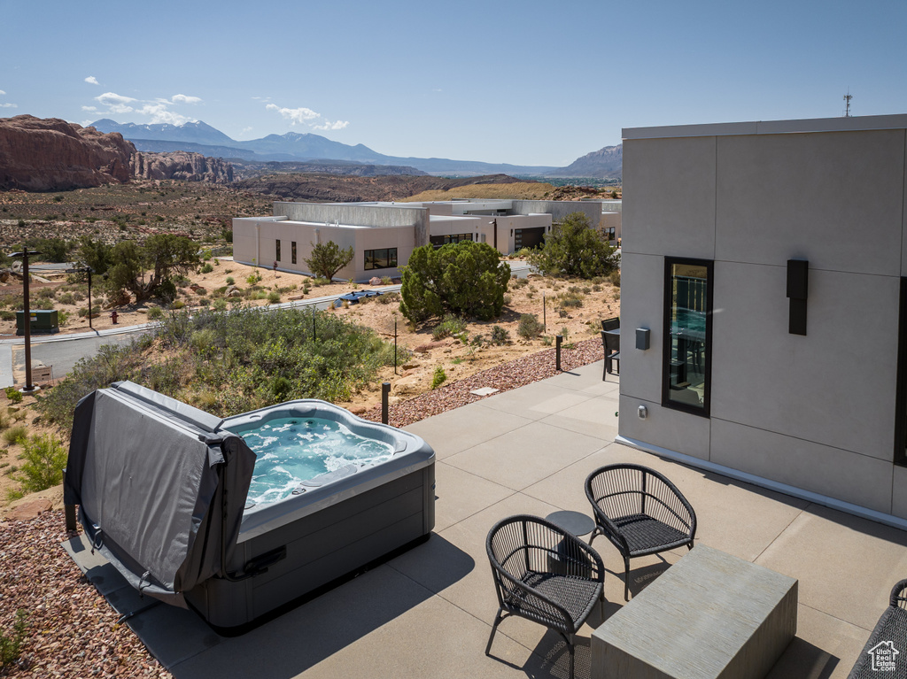 View of patio / terrace with a mountain view and a hot tub