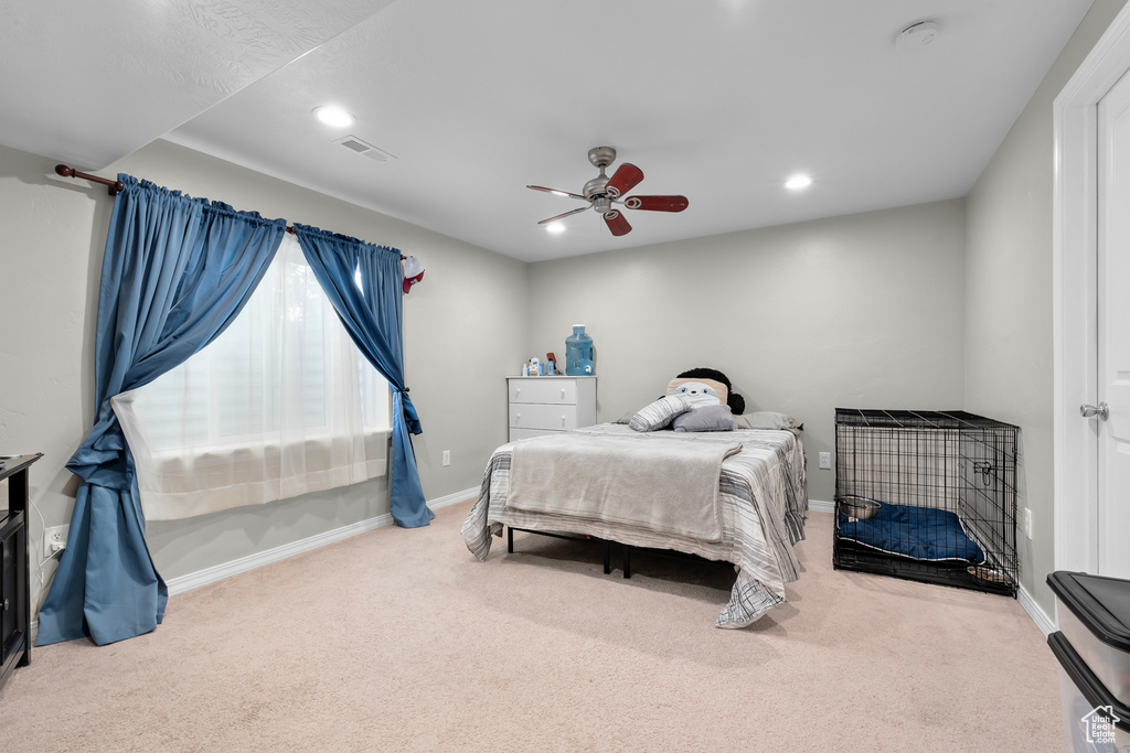 Bedroom with light colored carpet and ceiling fan