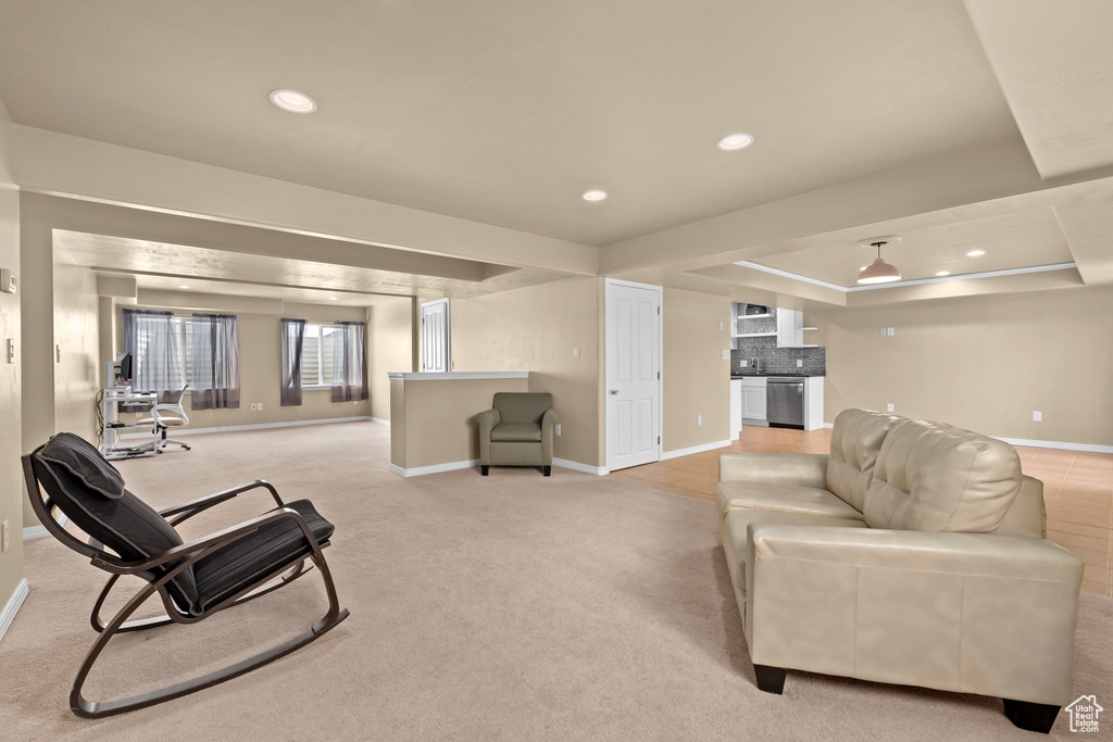Carpeted living room with a raised ceiling