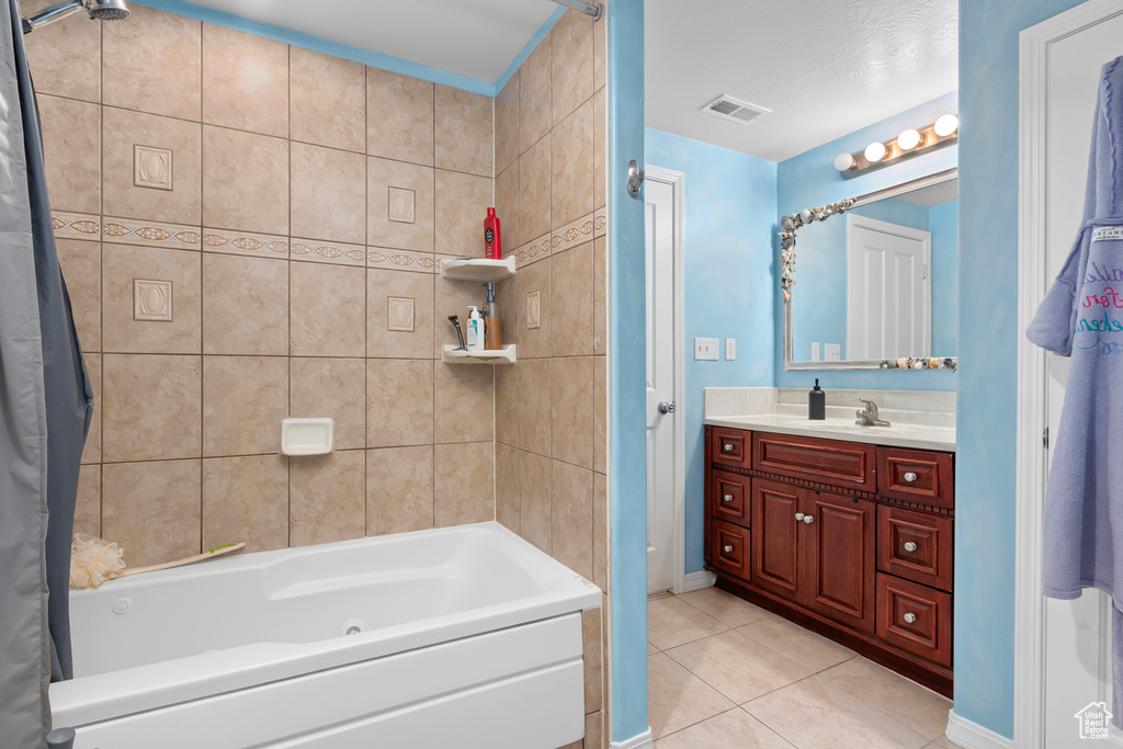 Bathroom with tile flooring, shower / bath combo, and large vanity