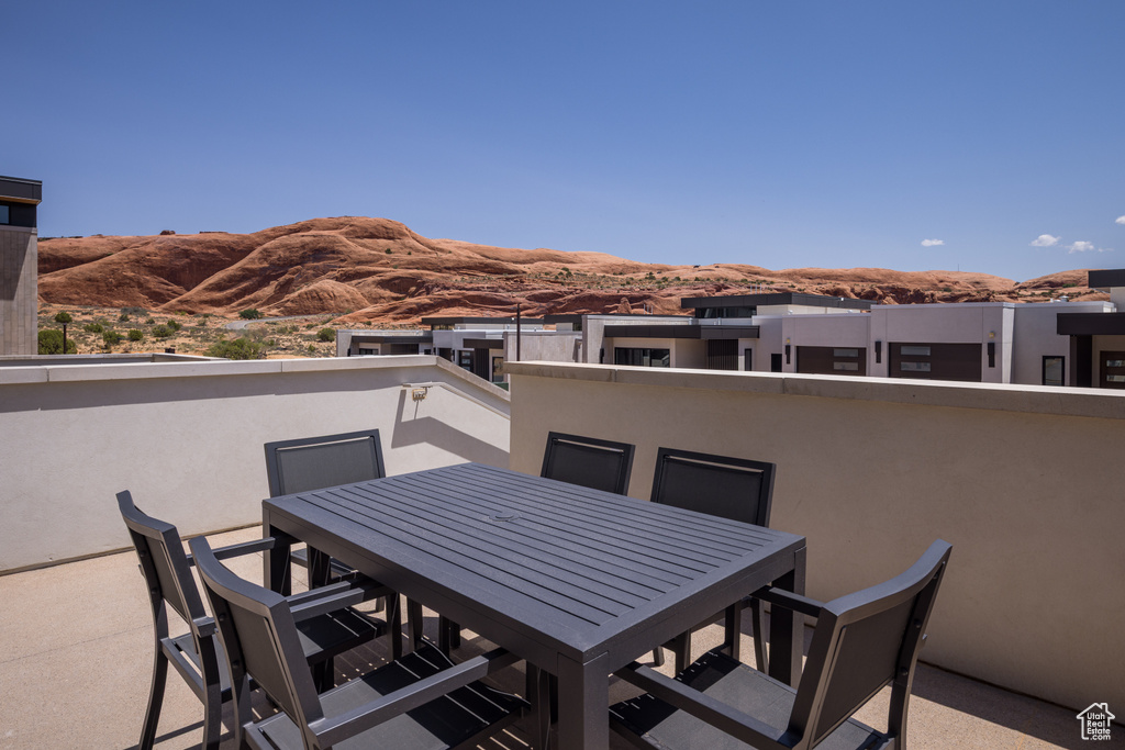 View of patio / terrace featuring a mountain view and outdoor dining space