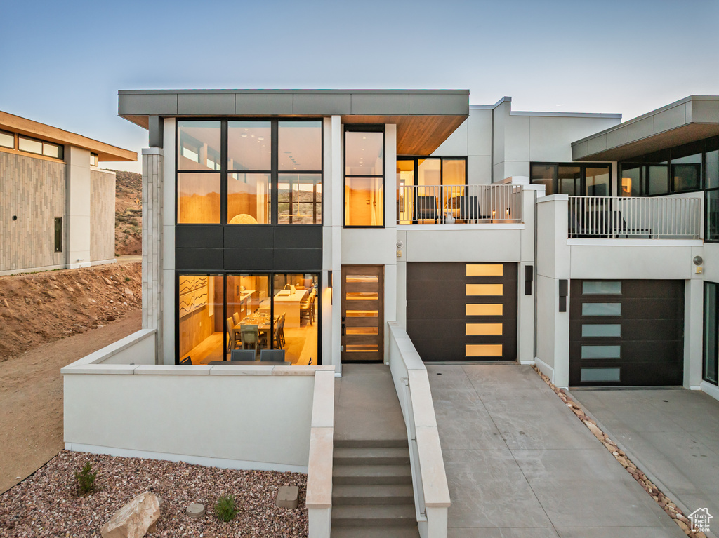 View of front facade with driveway and a garage