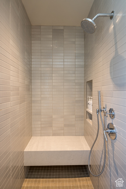 Bathroom featuring tiled shower and a sauna