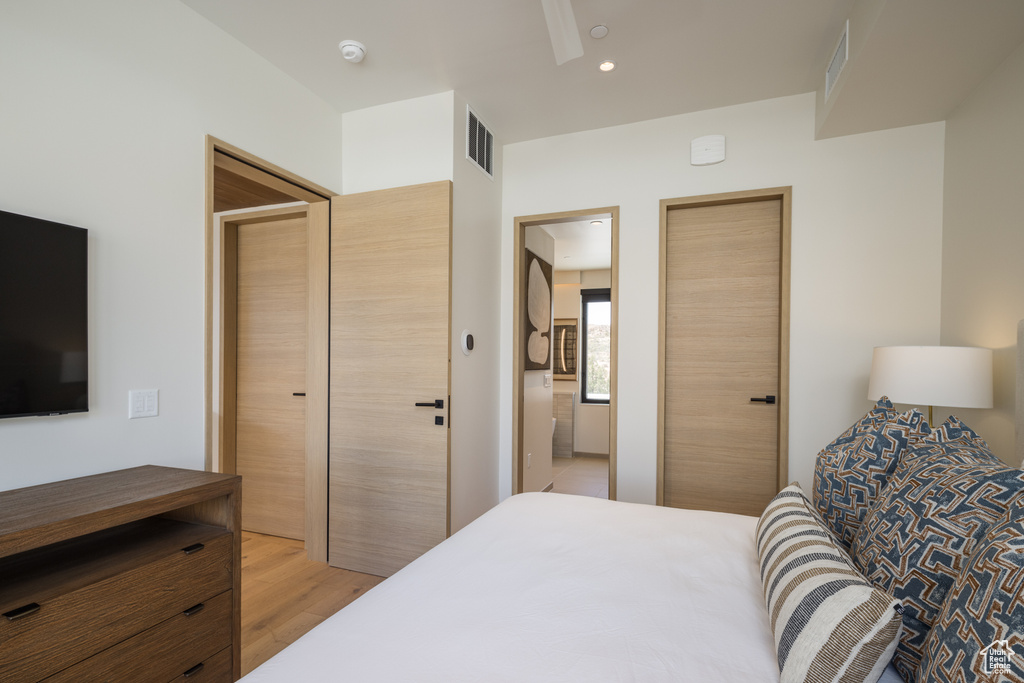 Bedroom with light wood-style floors and recessed lighting