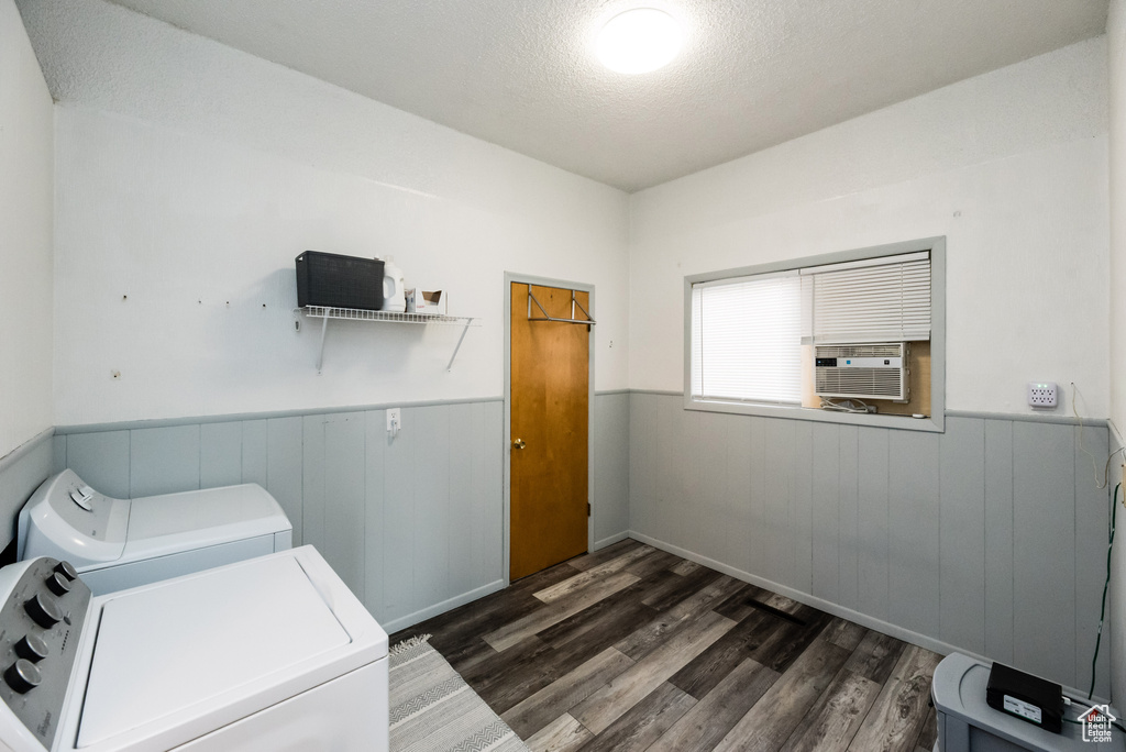 Laundry area with dark hardwood / wood-style floors and independent washer and dryer