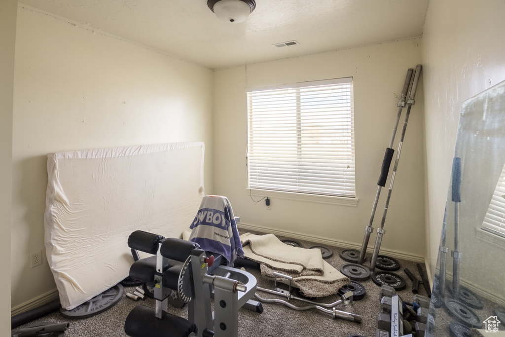 Workout room featuring dark carpet