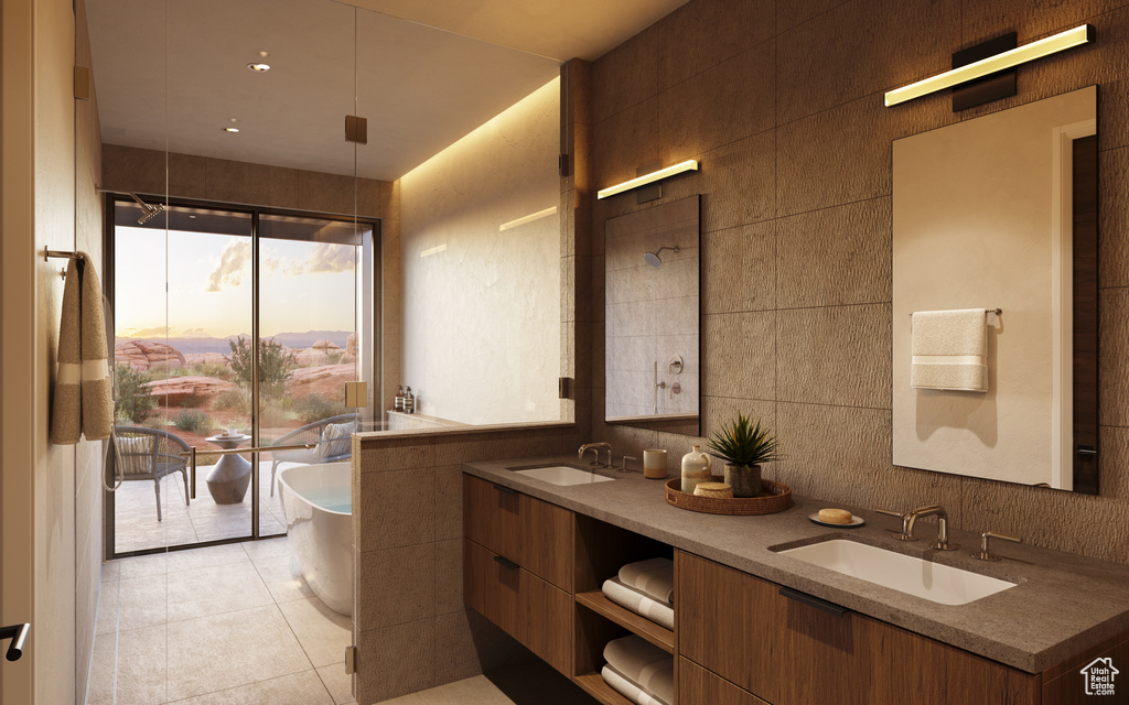 Bathroom featuring a washtub, tile walls, dual bowl vanity, and tile flooring