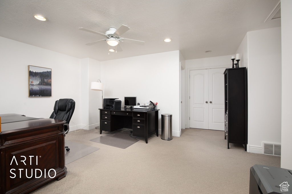 Office space featuring light carpet and ceiling fan