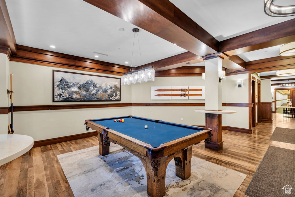 Rec room with billiards, ornate columns, light hardwood / wood-style floors, and beamed ceiling