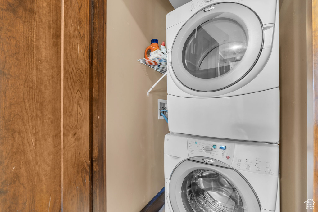 Laundry area with hookup for a washing machine and stacked washer and clothes dryer