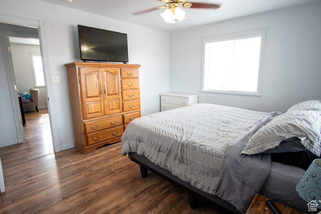 Bedroom with ceiling fan and dark hardwood / wood-style floors