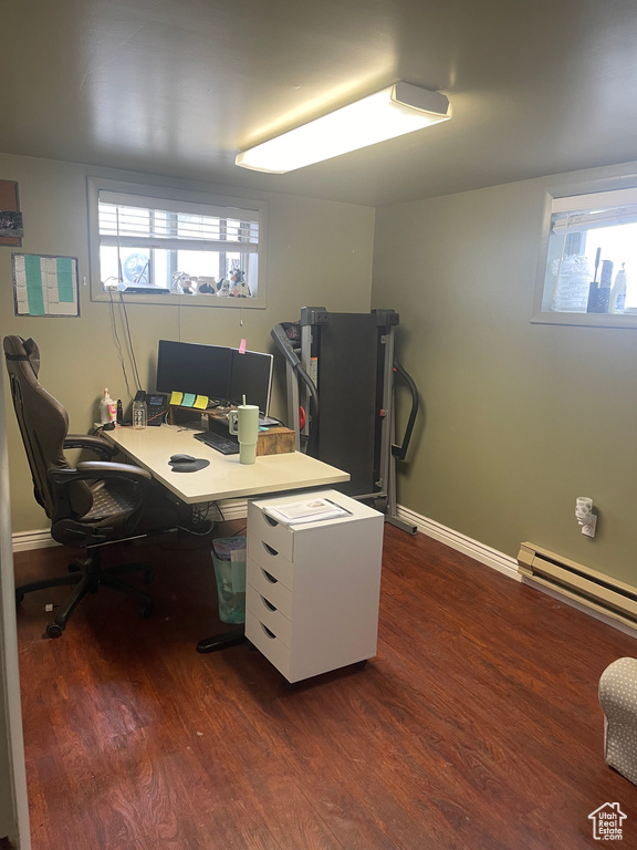 Office with a baseboard radiator and dark hardwood / wood-style flooring