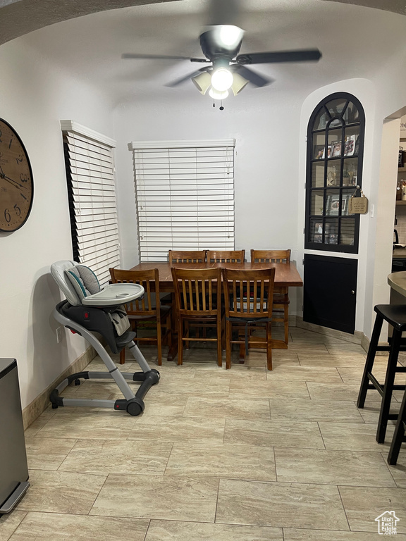Dining area with light tile floors and ceiling fan