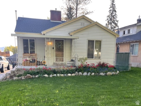 View of front of home featuring a front lawn and a porch