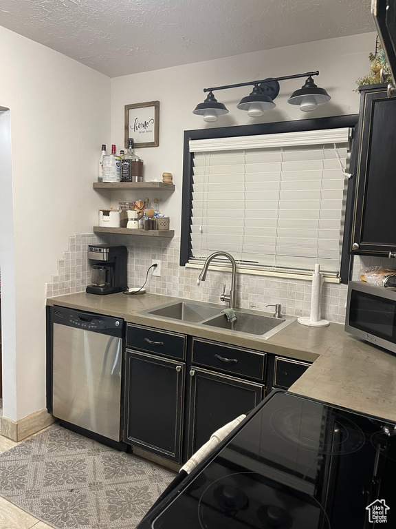 Kitchen featuring backsplash, sink, and stainless steel appliances