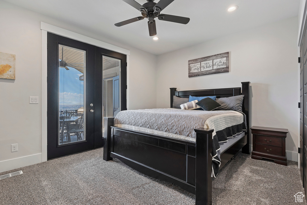 Bedroom featuring dark carpet, access to exterior, and ceiling fan
