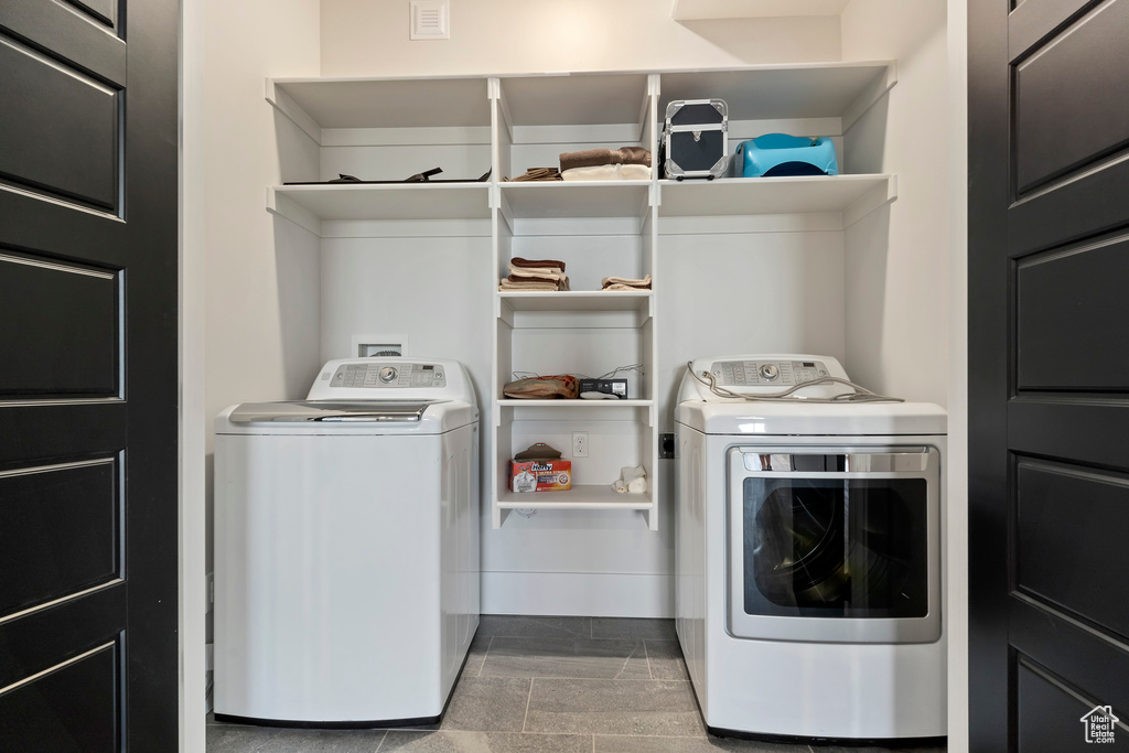 Laundry area featuring washing machine and dryer and tile floors