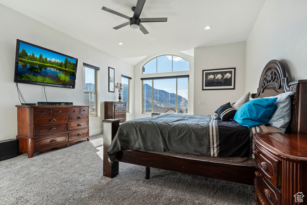 Carpeted bedroom with ceiling fan and a mountain view