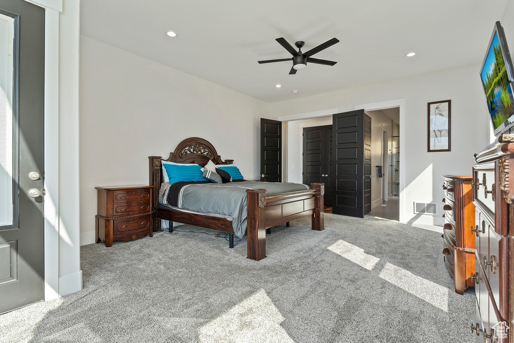 Carpeted bedroom with ceiling fan and a closet