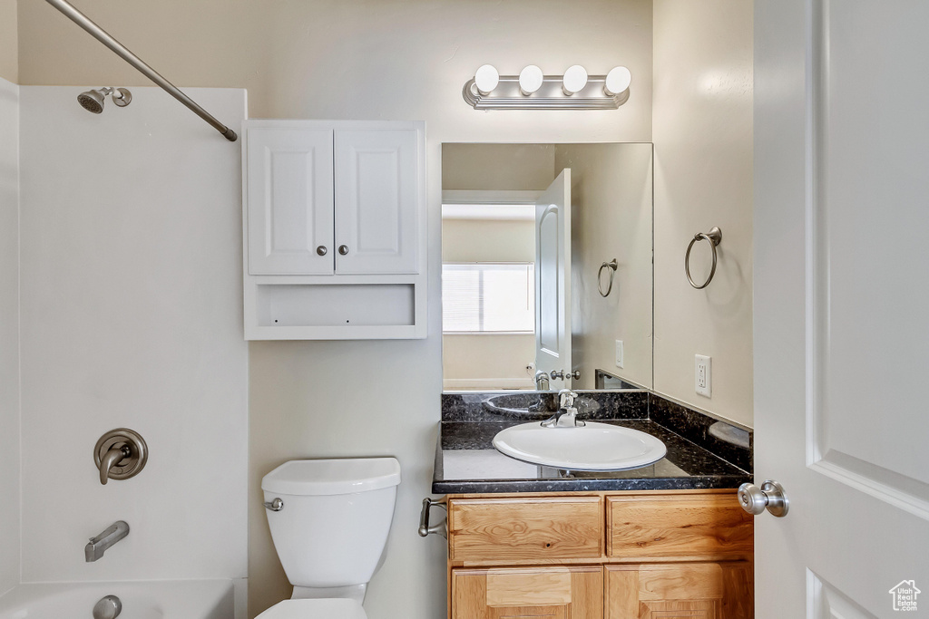 Full bathroom with shower / bath combination, oversized vanity, and toilet