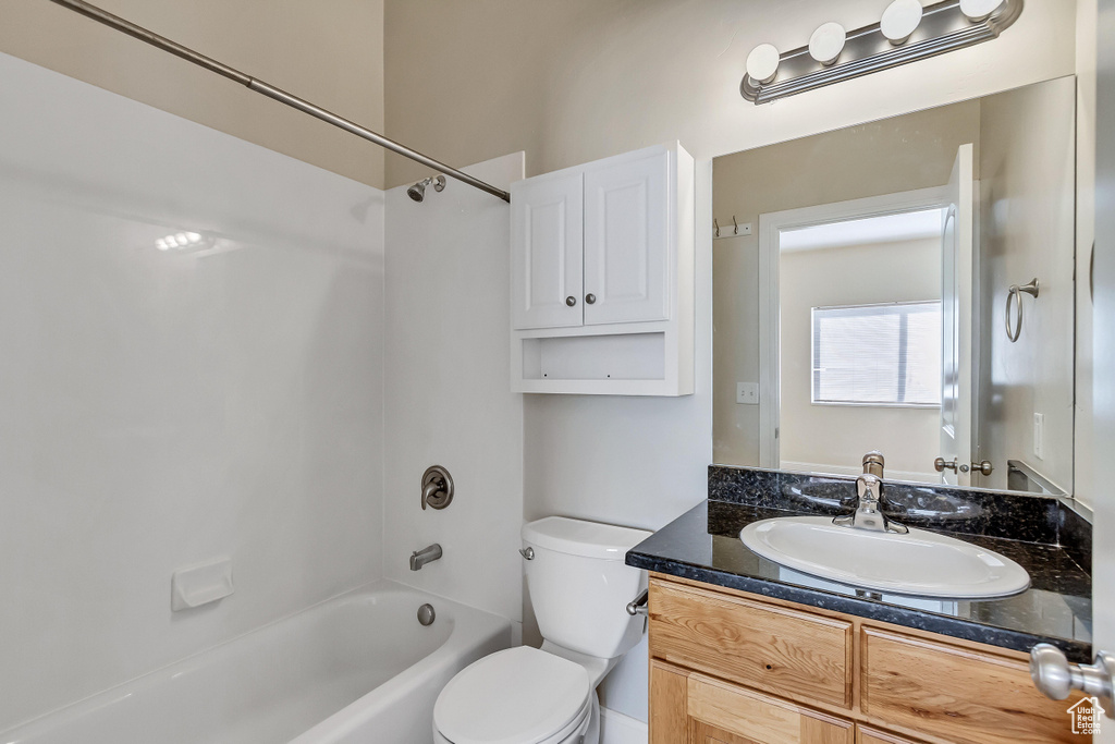 Full bathroom featuring vanity, toilet, and shower / washtub combination