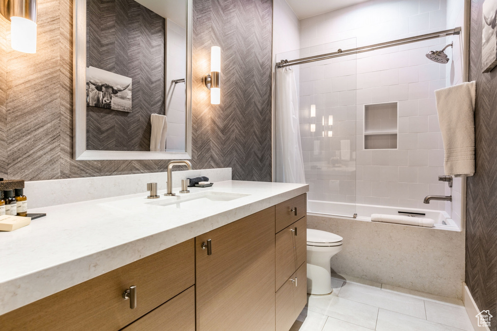 Full bathroom featuring tile patterned floors, vanity, toilet, and shower / bath combination with curtain