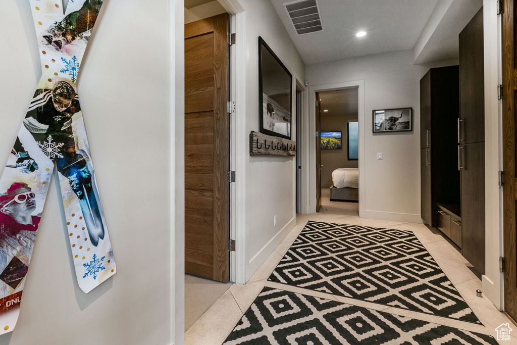 Hallway featuring light tile patterned flooring