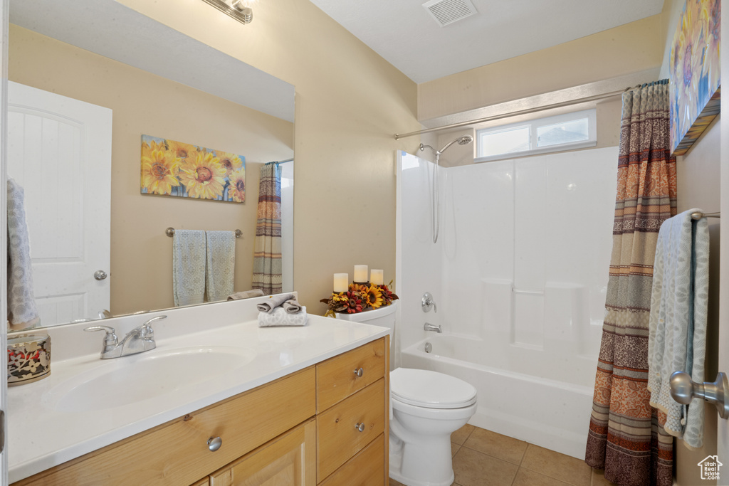 Full bathroom with vanity, toilet, shower / bathtub combination with curtain, and tile floors