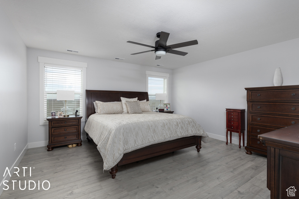 Bedroom featuring light hardwood / wood-style floors and ceiling fan