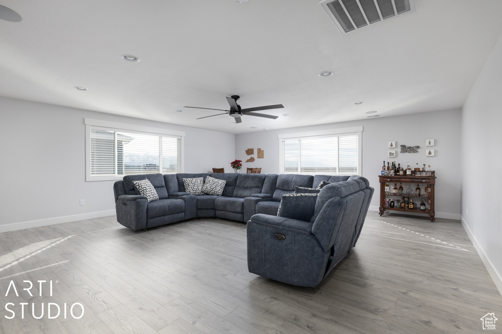 Living room featuring light hardwood / wood-style flooring, plenty of natural light, and ceiling fan