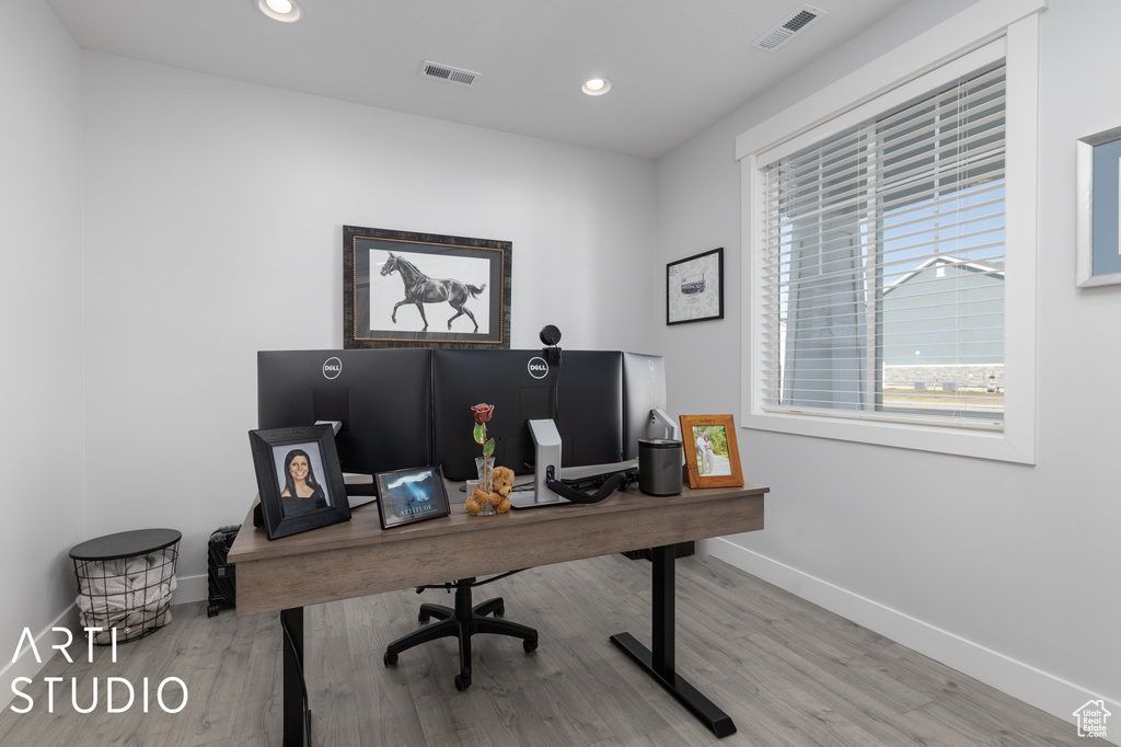 Office with light hardwood / wood-style floors
