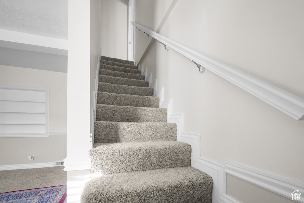 Stairway featuring built in features and carpet floors