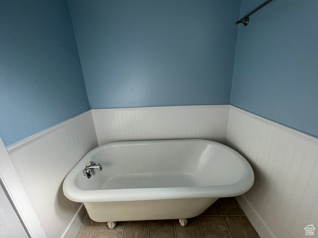Bathroom featuring tile floors and a bath
