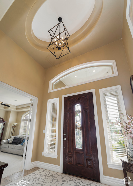 Foyer featuring a chandelier and a tray ceiling