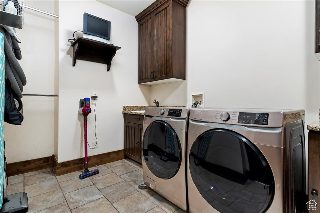 Laundry room with independent washer and dryer, cabinets, hookup for a washing machine, and light tile floors