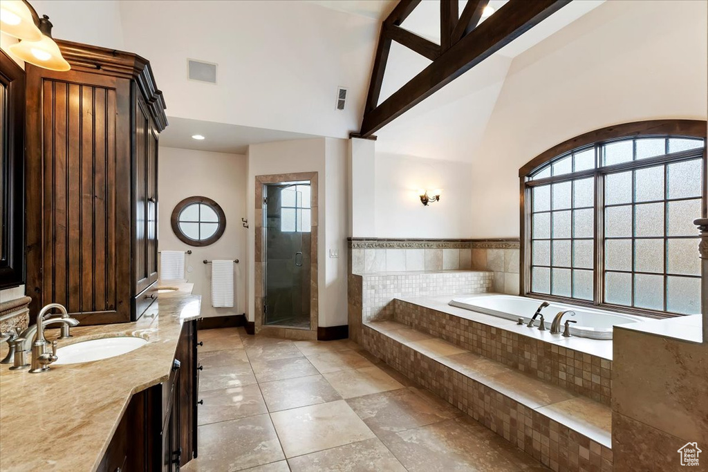 Bathroom featuring vanity, plus walk in shower, tile flooring, high vaulted ceiling, and beamed ceiling