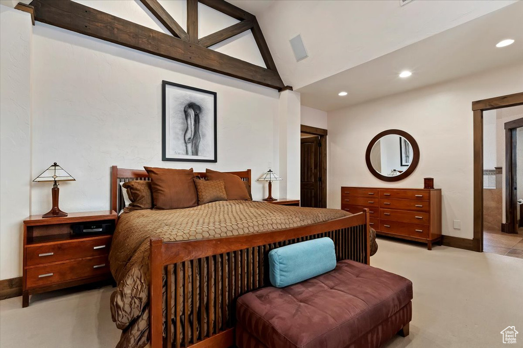 Tiled bedroom featuring vaulted ceiling with beams