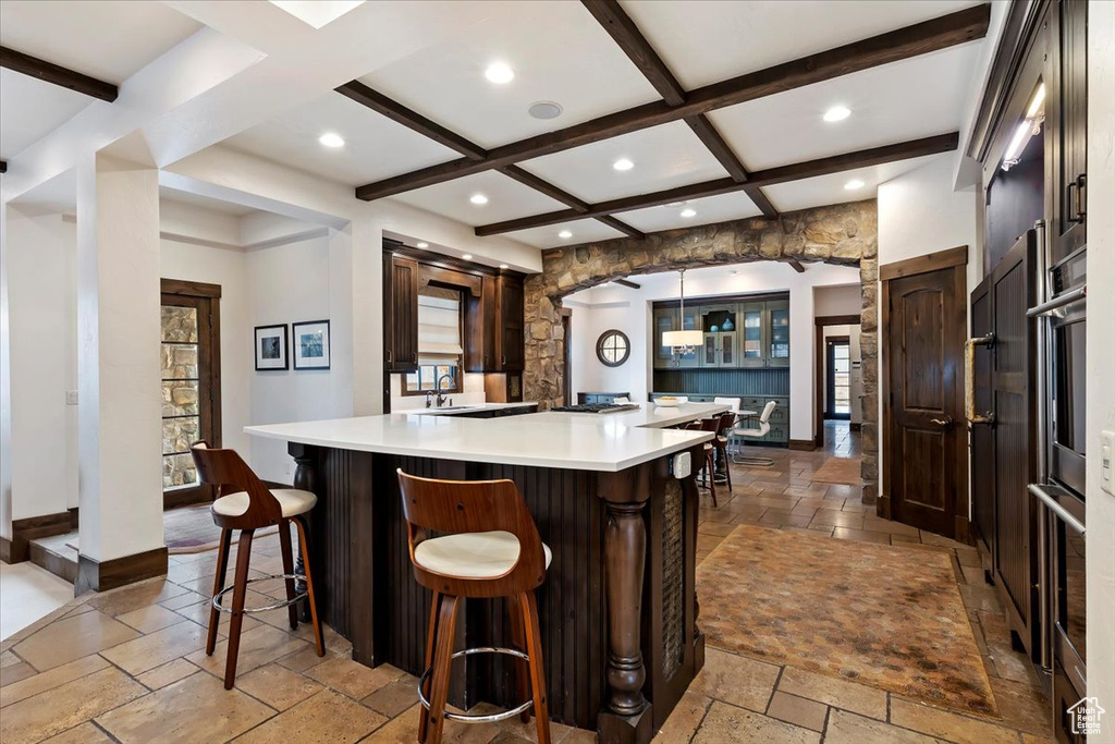 Kitchen with plenty of natural light, coffered ceiling, and light tile floors