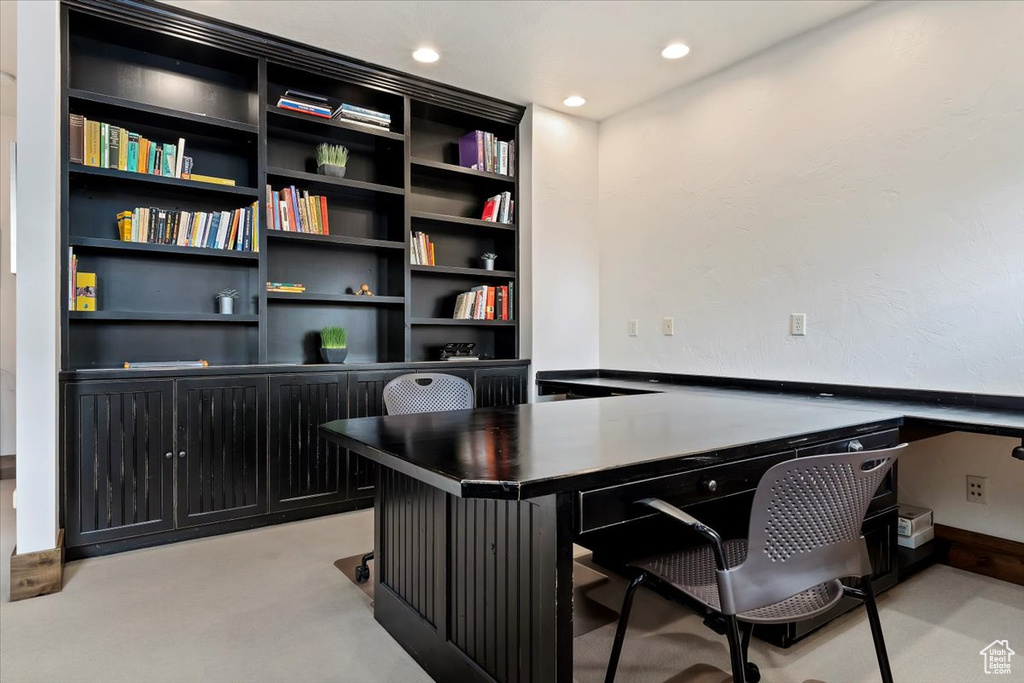 Office featuring light carpet and built in desk
