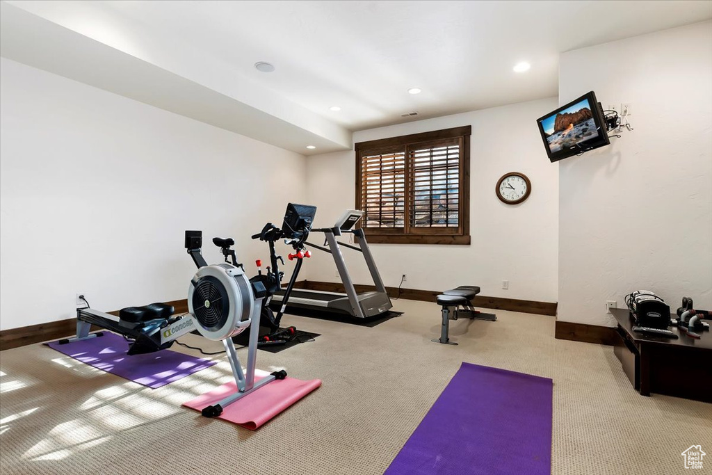 Workout area featuring light colored carpet