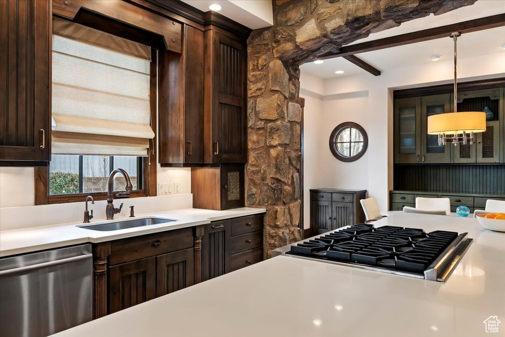 Kitchen with pendant lighting, dishwasher, sink, and dark brown cabinetry