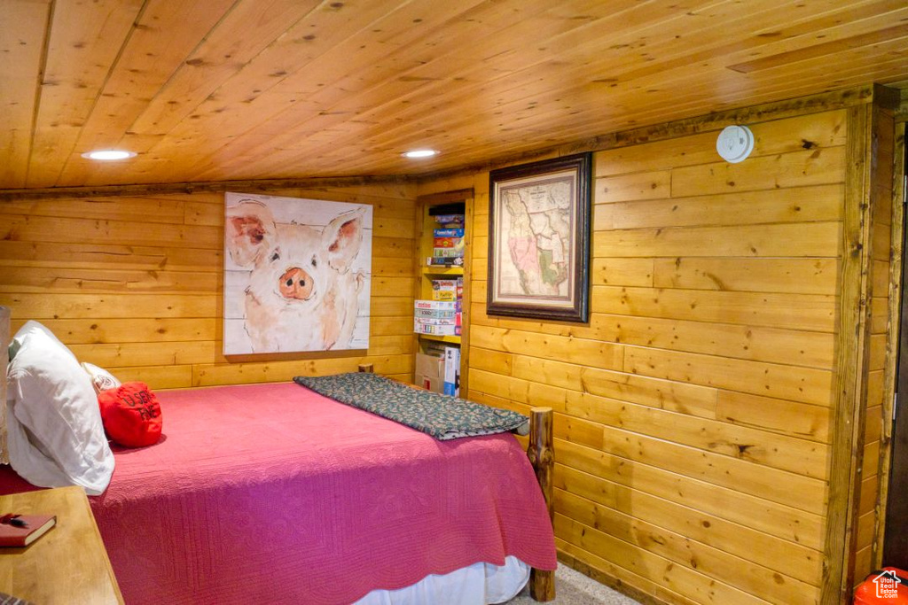 Bedroom with wooden ceiling and wooden walls